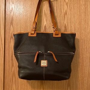 This is a dark brown and natural leather tote